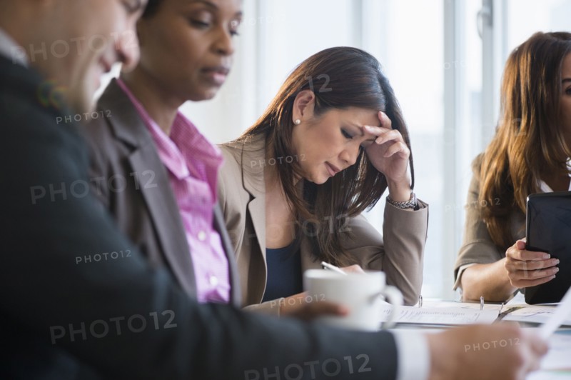 Businesswoman making notes in meeting