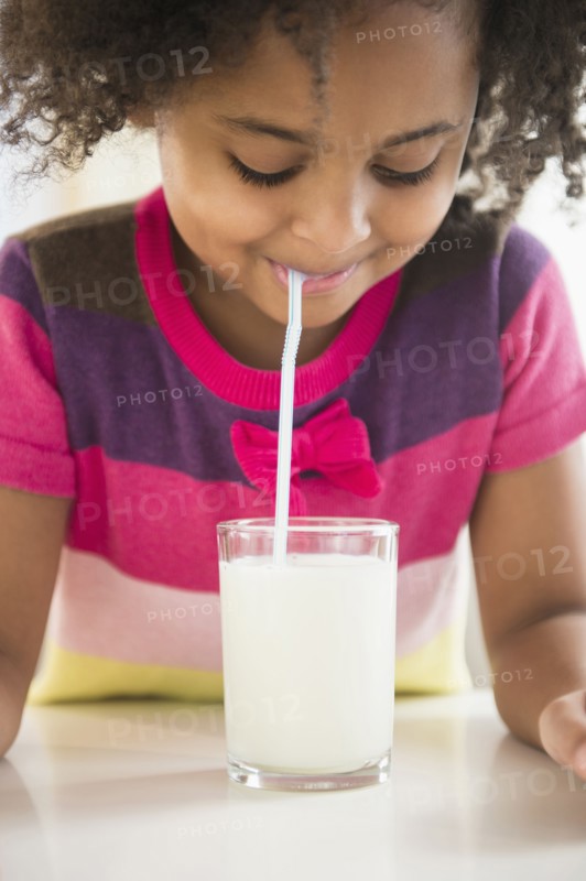 African American girl drinking glass of milk