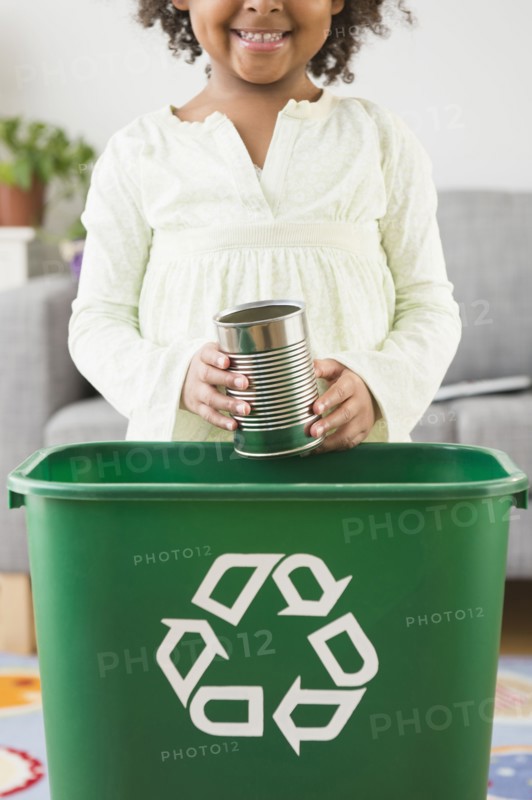 African American girl recycling can