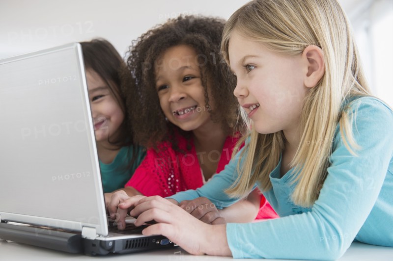 Girls using laptop together