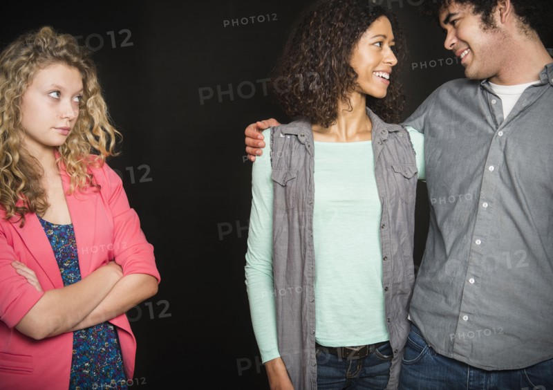Smiling couple ignoring friend