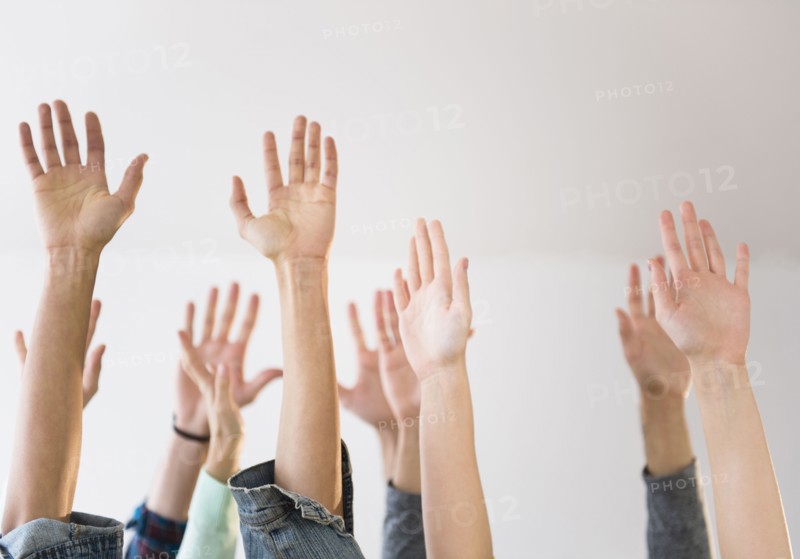 People's hands raised in air