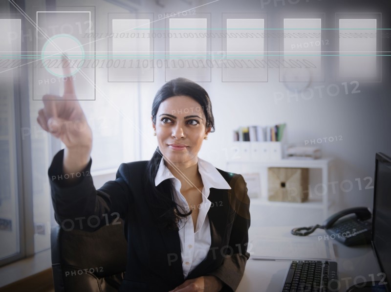 Indian businesswoman using touchscreen