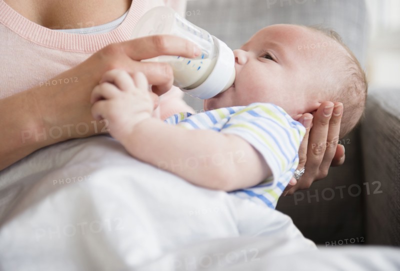 Caucasian mother bottle feeding baby