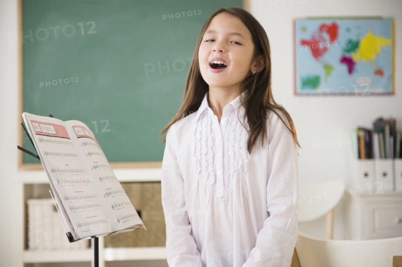 Mixed race girl in singing class