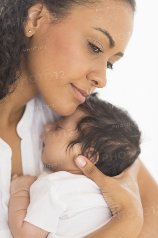 Hispanic mother holding infant son