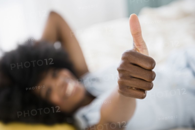 Mixed race woman giving thumbs up