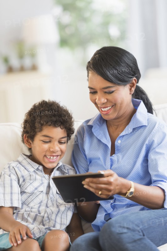 Mother and son using digital tablet
