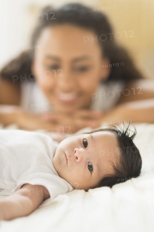 Hispanic mother admiring baby