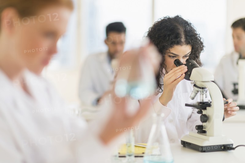 Scientist using microscope in laboratory