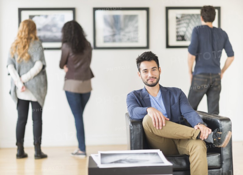 Artist smiling in art gallery