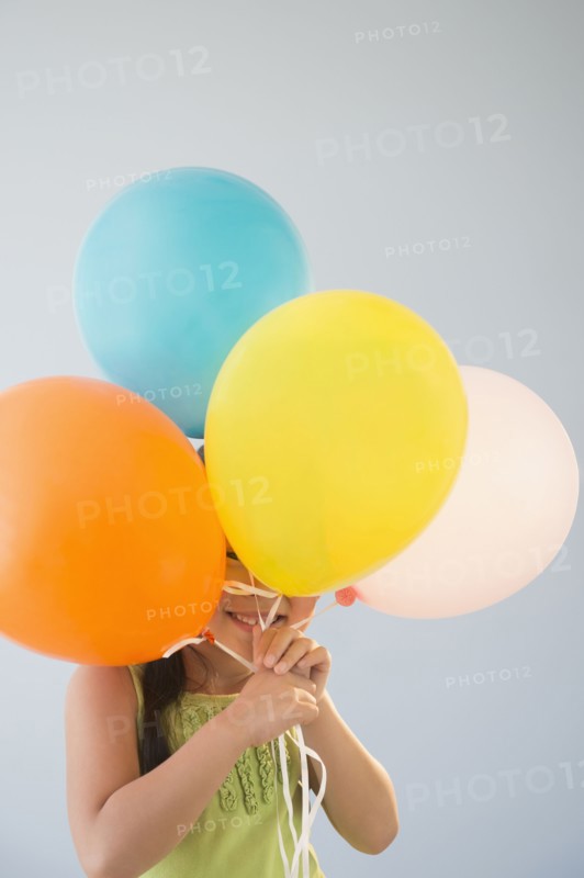 Korean girl hiding behind bunch of balloons