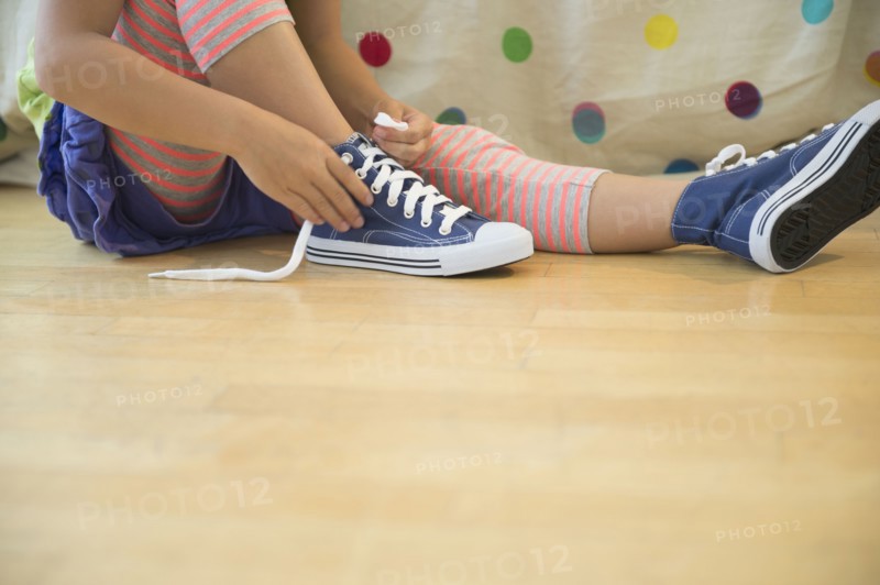 Korean girl tying shoelaces