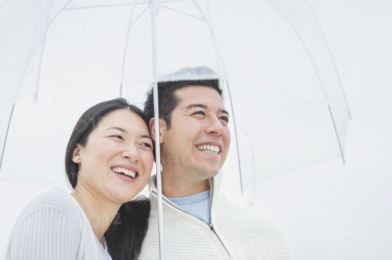 Couple hugging under umbrella