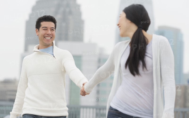 Couple holding hands in city