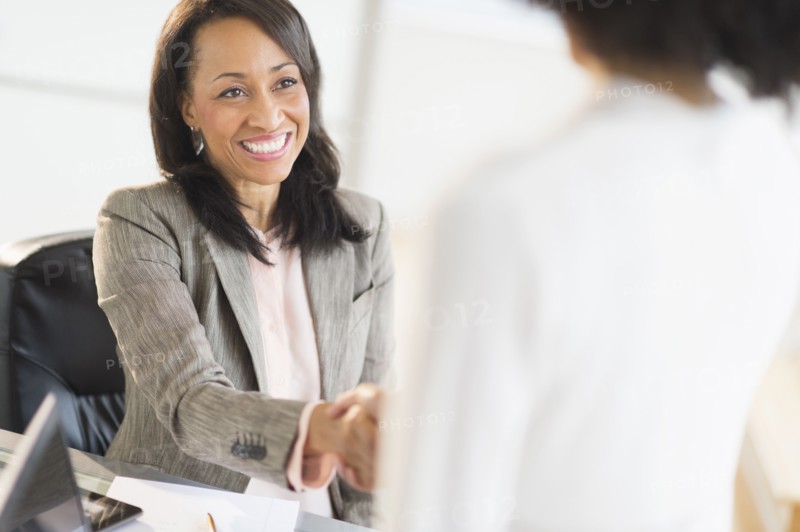 African American businesswomen shaking hands