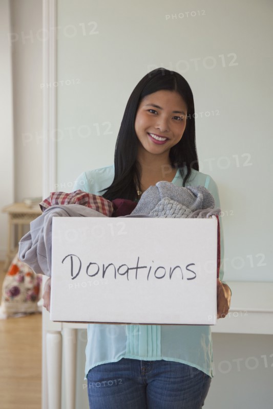 Chinese woman holding donations box