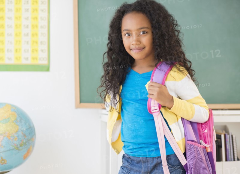 Mixed race student smiling in classroom