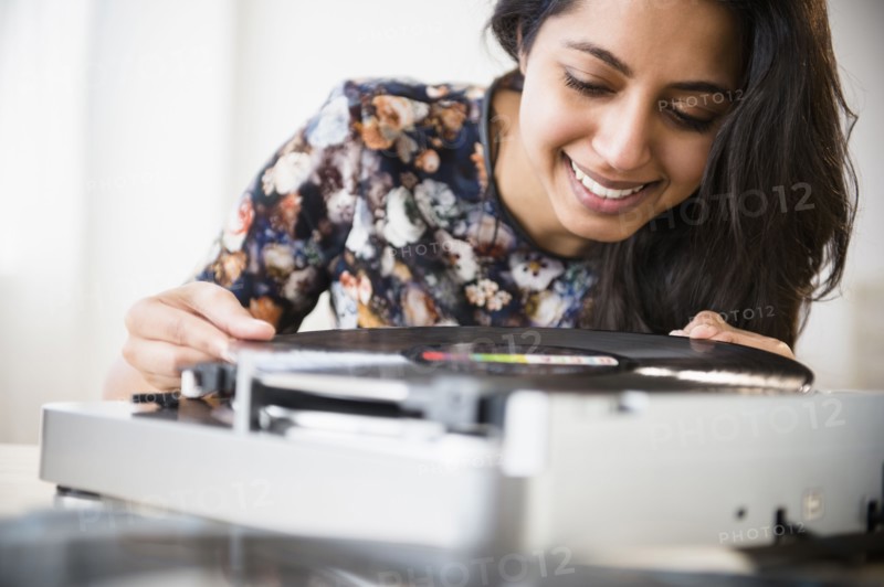 Close up of Asian woman using record player