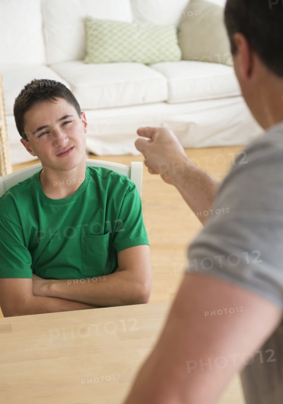 Caucasian father scolding angry son