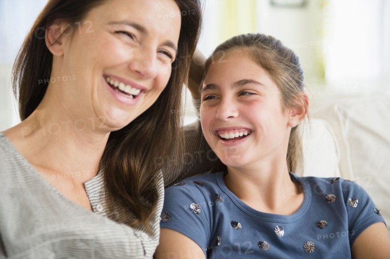 Close up of Caucasian mother and daughter laughing