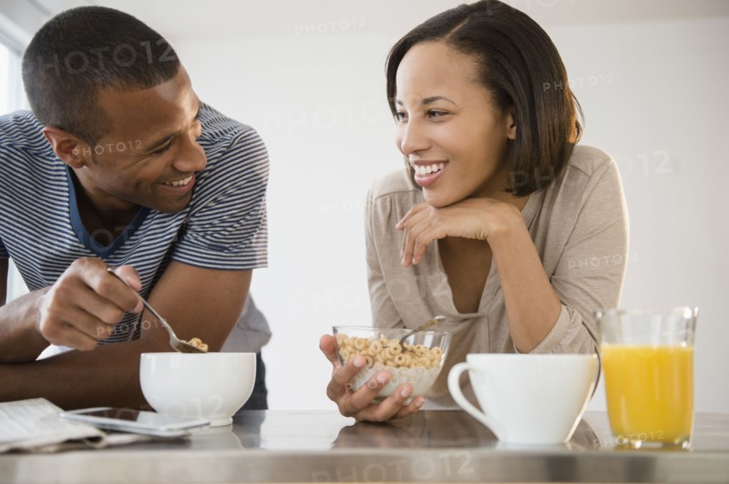 Happy couple eating cereal