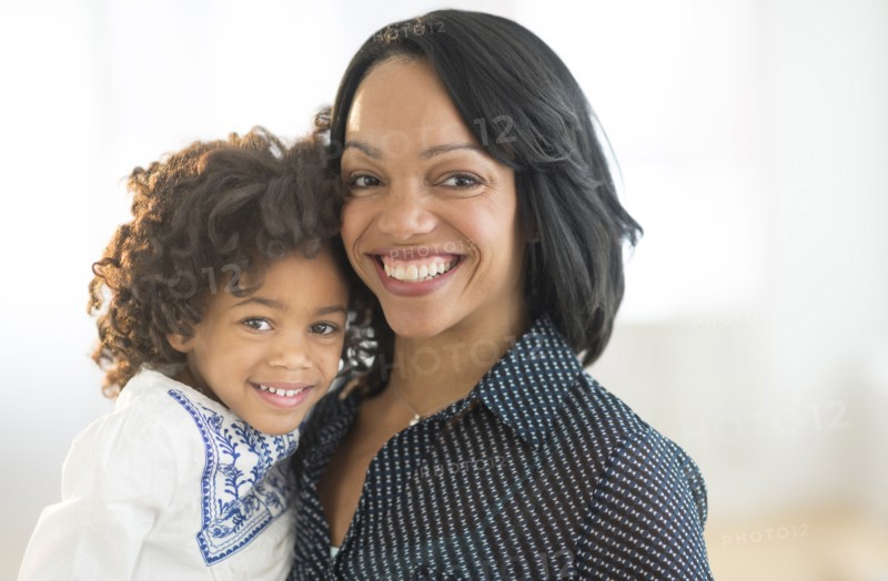 Portrait of smiling African American mother and daughter