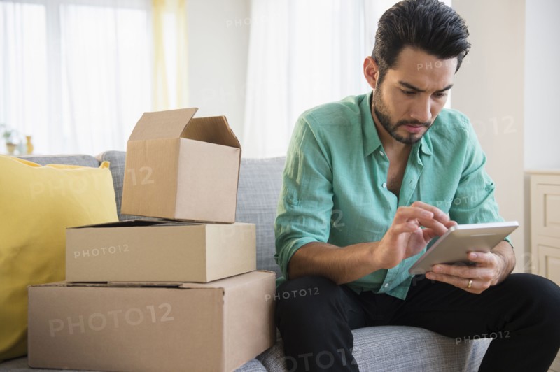 Mixed race man using digital tablet and moving