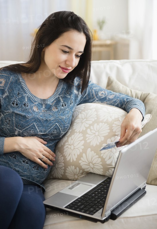 Pregnant Caucasian woman shopping online