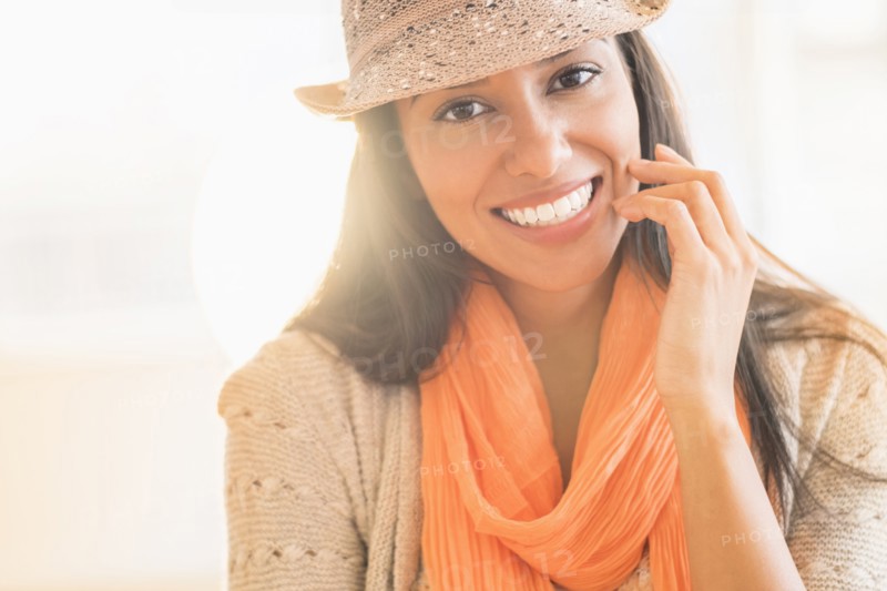 Hispanic woman in fedora and scarf