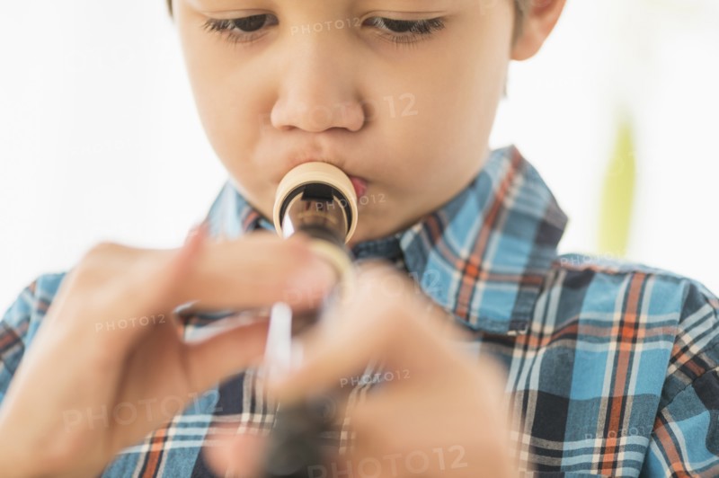 Hispanic boy practicing recorder