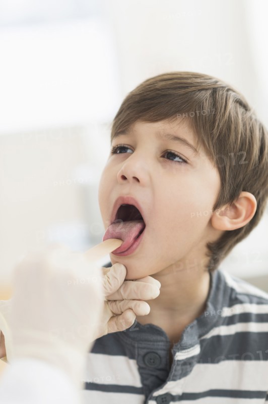 Hispanic boy getting a checkup at doctor's office