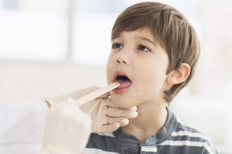 Hispanic boy getting a check up at doctor's office