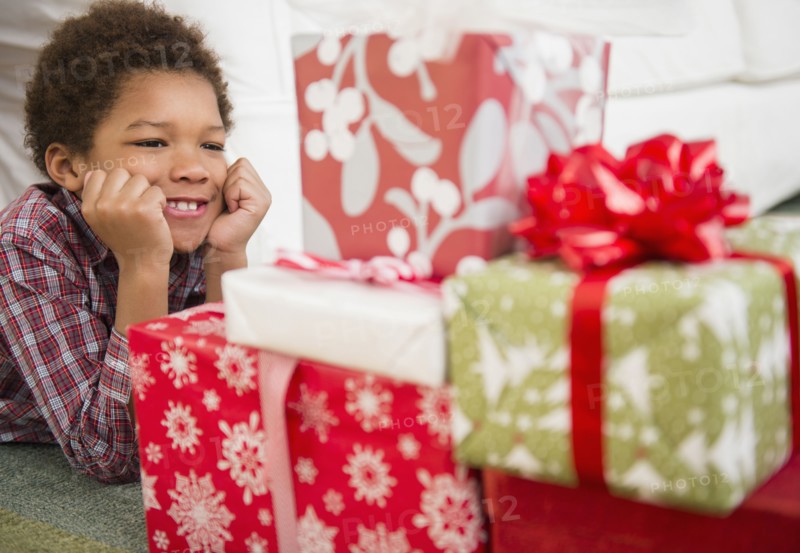 Black boy admiring Christmas presents
