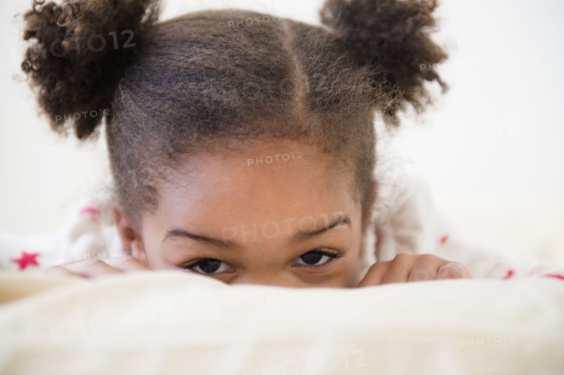 Black girl playing on bed