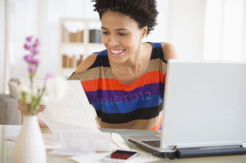 Black woman paying bills online
