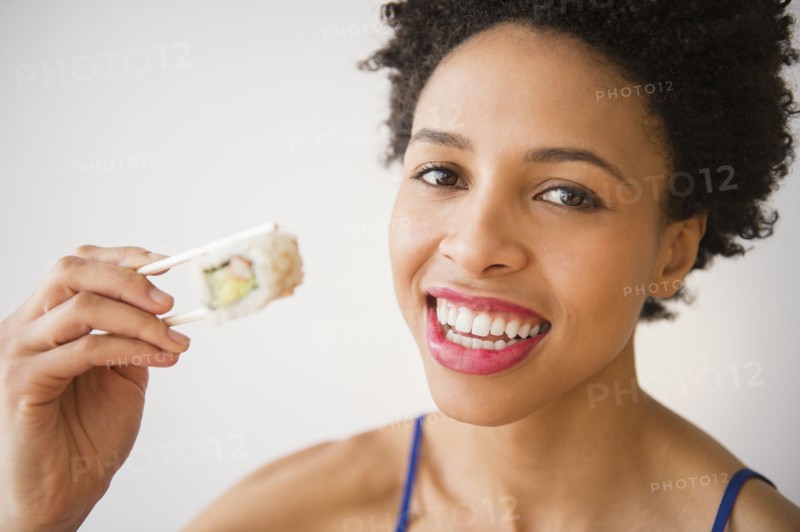 Black woman eating sushi