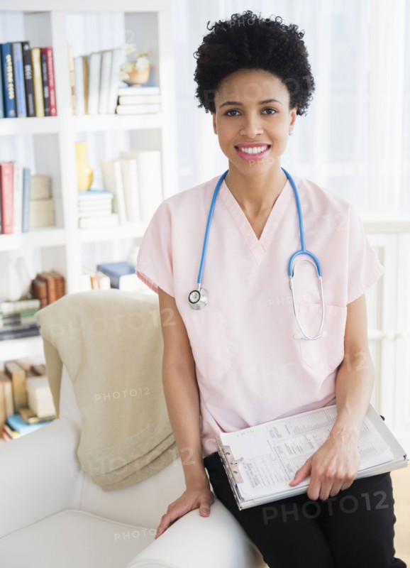 Black nurse smiling at home visit