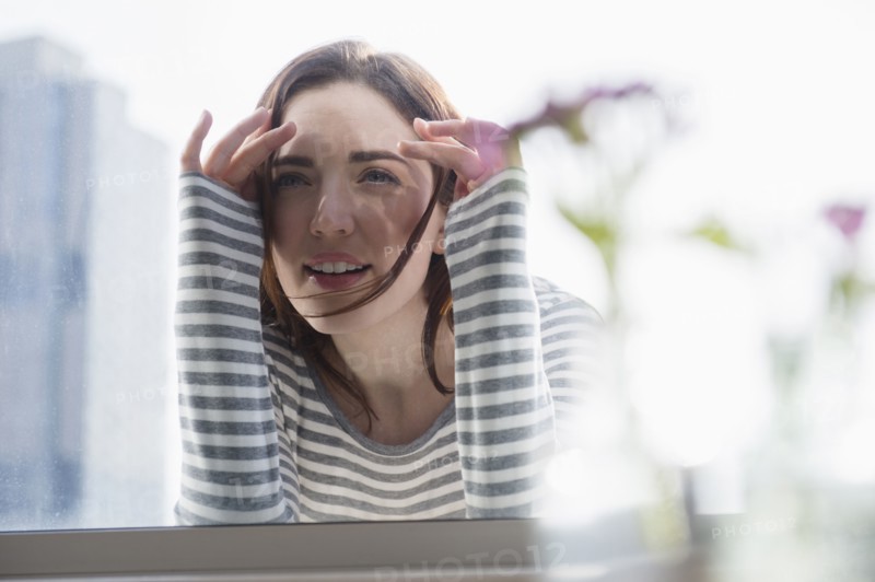 Woman peering in through window