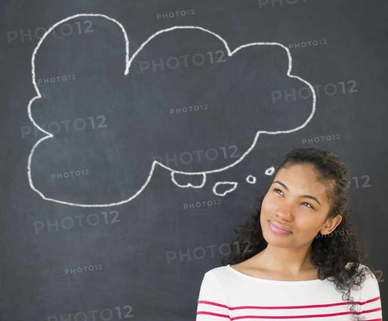 Mixed race woman under thought bubble on chalkboard
