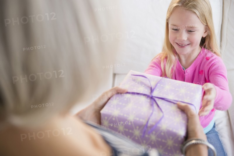 Senior Caucasian woman giving granddaughter present