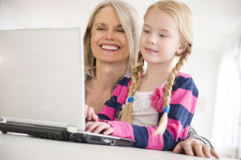 Senior Caucasian woman and granddaughter using laptop
