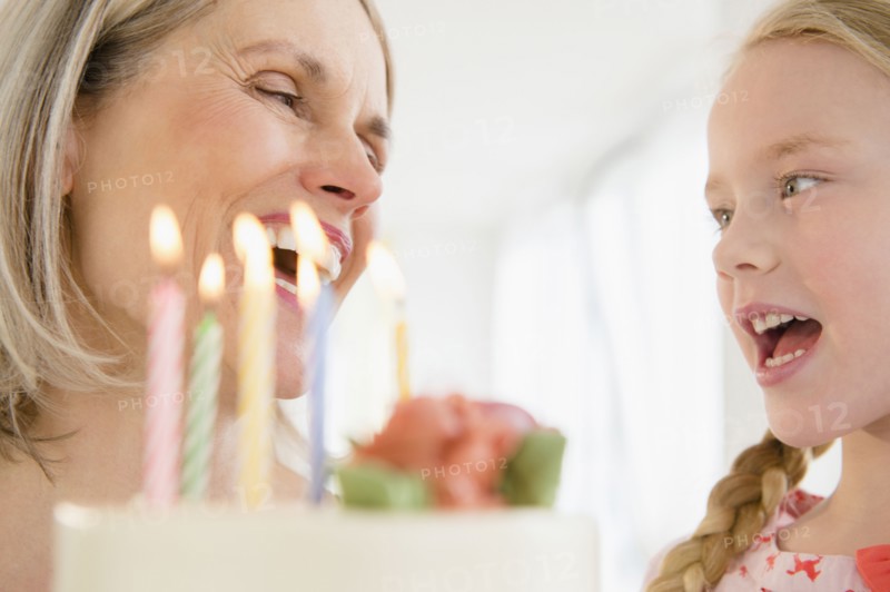 Senior Caucasian woman and granddaughter celebrating birthday