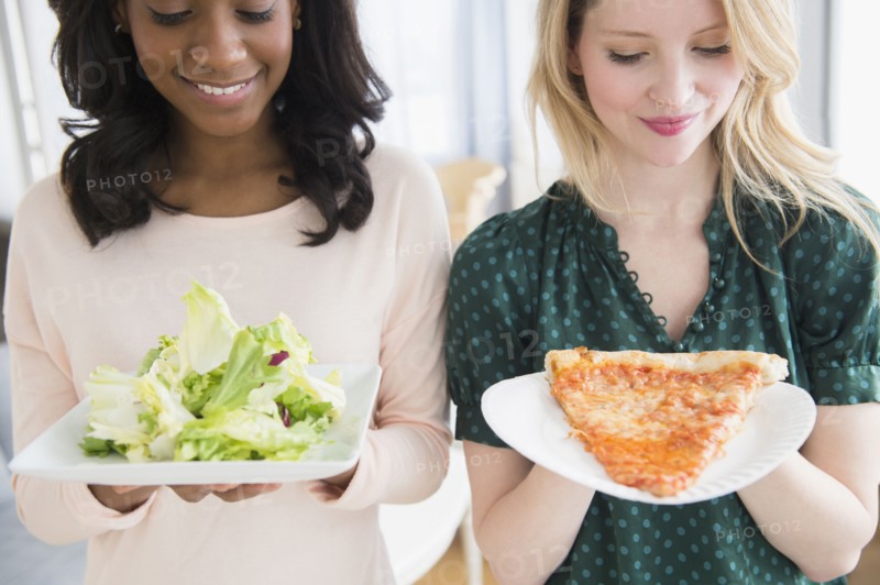 Women eating pizza and salad