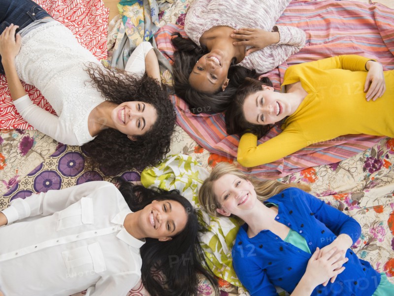 Women relaxing together on blankets