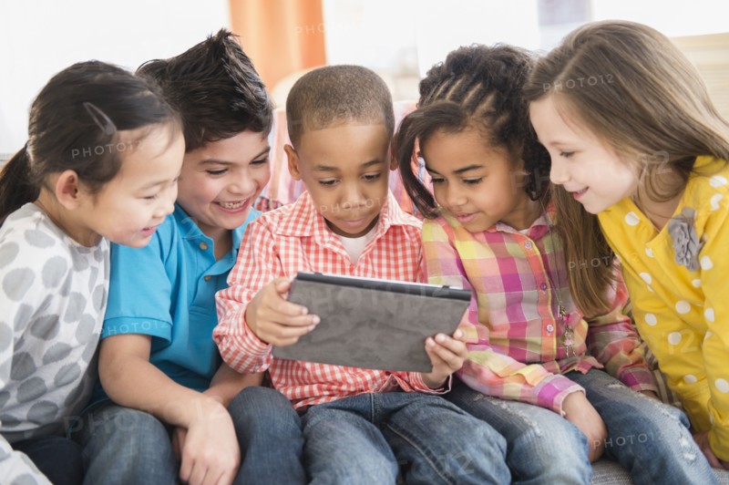 Children using digital tablet together