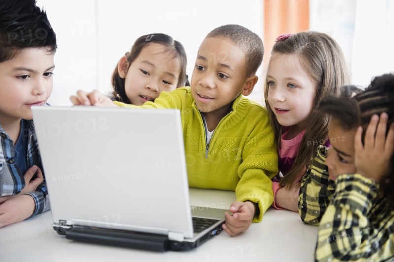 Children using laptop together