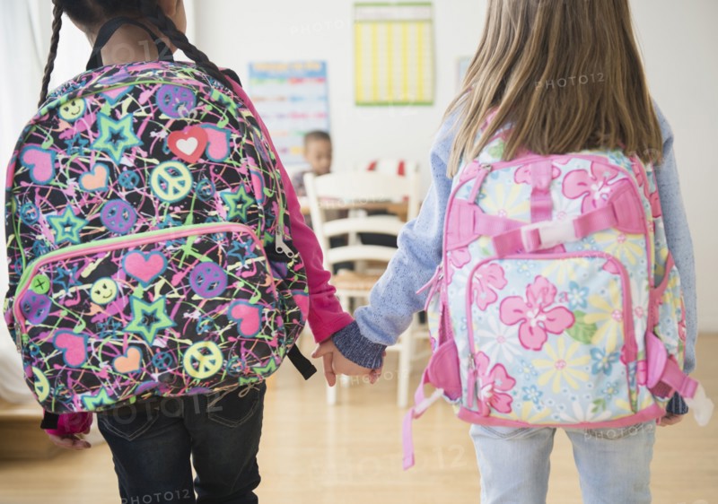 Students holding hands in classroom