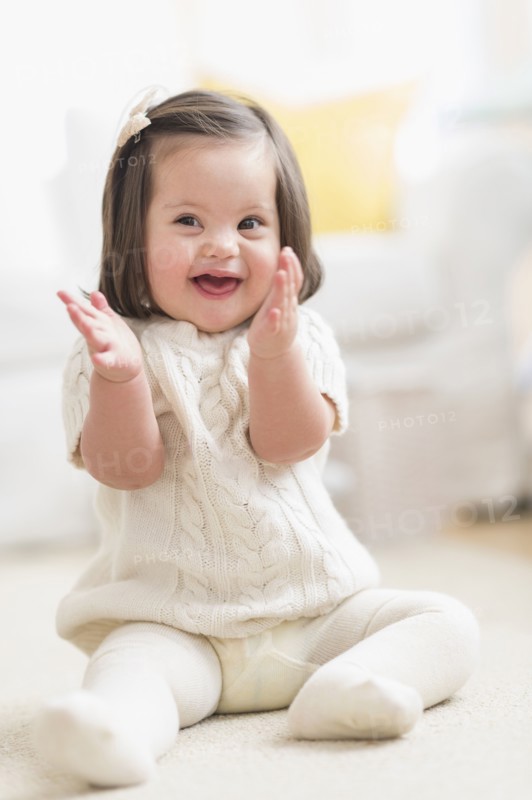 Hispanic toddler with Down syndrome playing