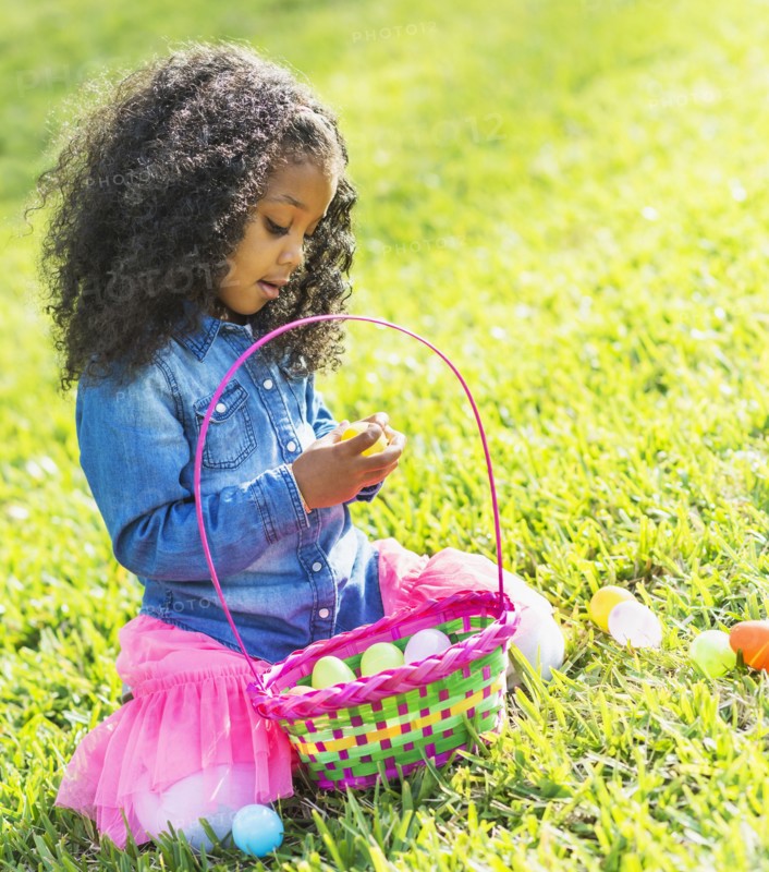 Mixed race girl hunting for Easter eggs